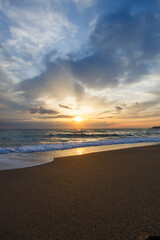 A breathtaking sunset over the calm Mediterranean waters of Alanya. The golden glow illuminates the tranquil waves as the sun sinks beyond the horizon, creating a sense of harmony, and freedom