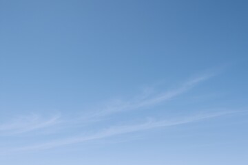 Serene Blue Sky with Wispy Clouds: A Versatile Background for Design and Creative Projects