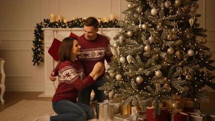 Family Decorating Christmas Tree Together In Cozy Living Room.
