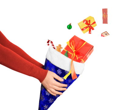 Hands holding a blue Christmas stocking with flying gifts and decorations isolated on white background.