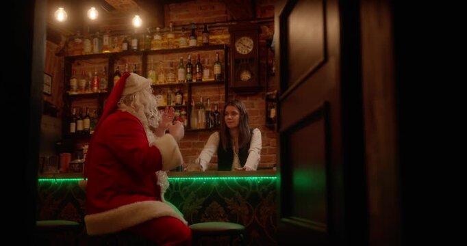 Santa claus talking to a bartender in a pub