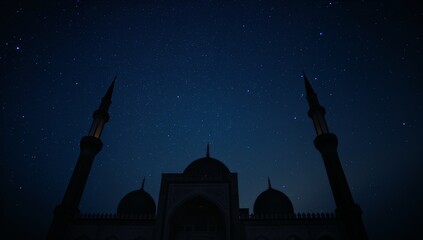 Silhouette of a mosque with minarets under a starry night sky in a dark blue color palette