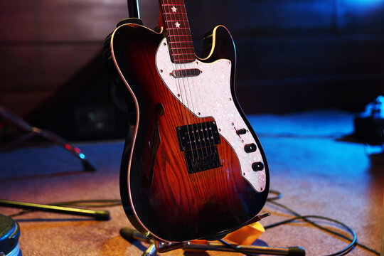 Modern electric guitar on stage, closeup. Musical instrument