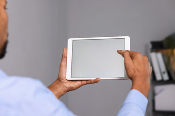 African-american man using tablet in office, closeup