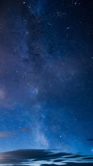 Fototapeta premium Starry Night Sky with Subtle Clouds - Deep Blue Tones, Vertical 4K Wallpaper