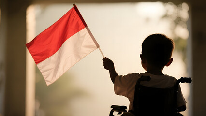 A young boy in a wheelchair proudly holds the Indonesian flag, symbolizing independence and resilience.