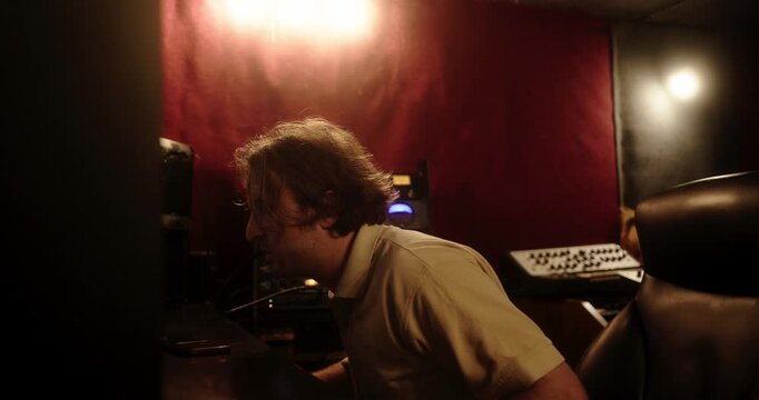 Sound engineer mixing tracks in a professional recording studio