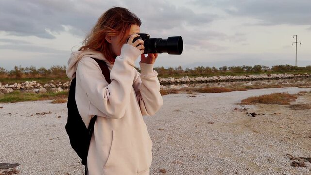 20s woman using camera to capture landscape and water birds at Gediz Delta Sasalı Bird Paradise
