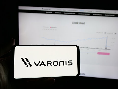 Stuttgart, Germany - 11-21-2025: Person holding smartphone with logo of US software company Varonis Systems Inc. on screen in front of website. Focus on phone display.
