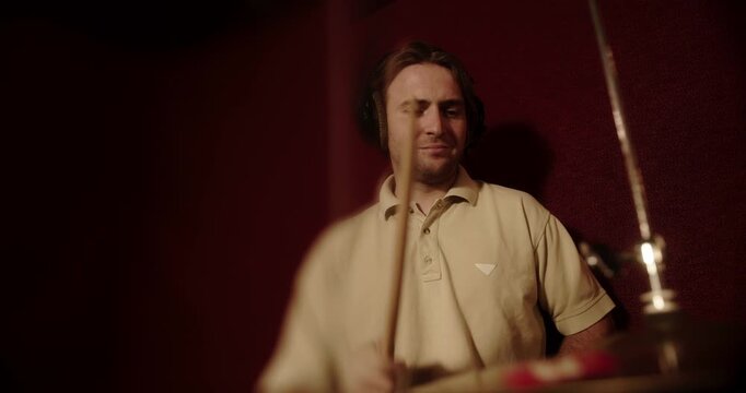 Professional musician playing drums in recording studio