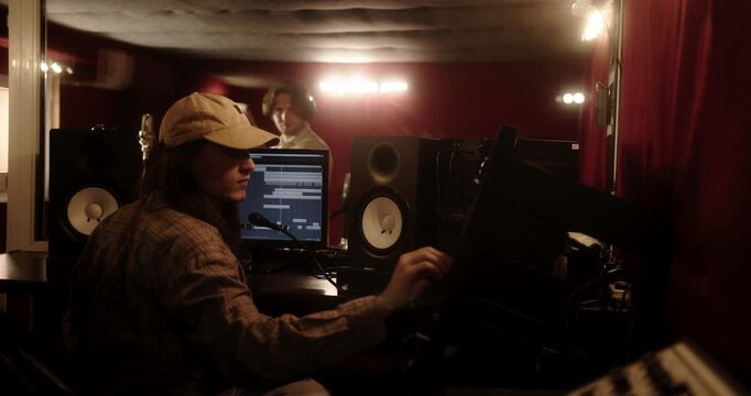 Music producer creating new song in professional recording studio