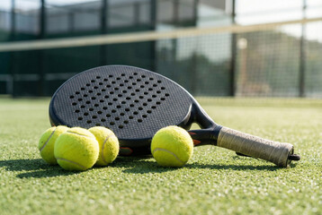 tennis gear ready, prepared paddle tennis items set against textured synthetic grass on sunny day