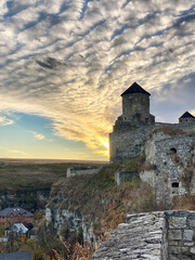 Fototapeta premium Ancient stone fortress on a hill at sunset