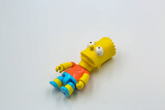 Bart Simpson toy figure closeup on white background.