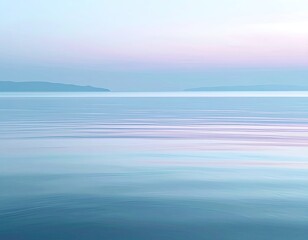 Obraz premium Serene coastal scene with tranquil, glassy water under a pastel sky. Distant land visible