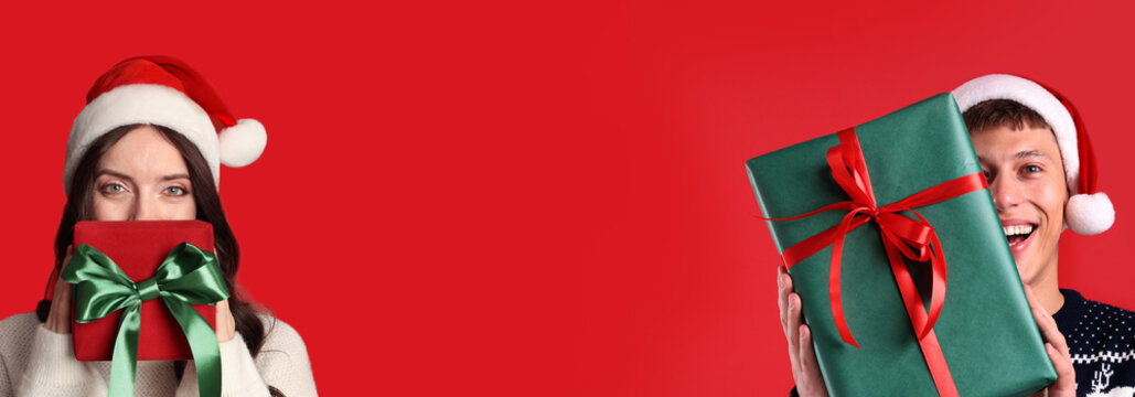 Christmas banner design with happy woman and man holding gift boxes on red background. Space for text