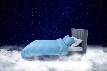 Fototapeta premium Large bed on fluffy clouds in starry night sky