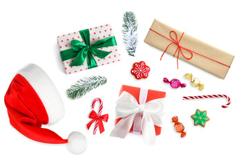 Gift boxes and sweets flying out of Santa hat on white background