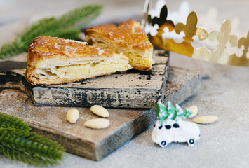 Two pieces of galette retro cutting board with crown on table.