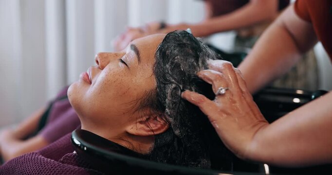 Woman, washing or hands with hair massage in salon for grooming, spa or haircare treatment. Female person, customer and hairdresser applying cosmetics with soap for clean keratin in beauty parlor