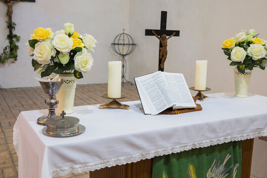 Sacred morning ceremony, Church setup with symbols of faith, Preparation of sacred space for morning worship, Serene chapel arrangement with candles and religious icons
