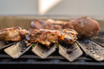Chicken pieces grilling on barbecue for a delicious meal