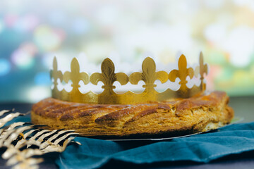 Delicious royal galette with crown on a table with boke.