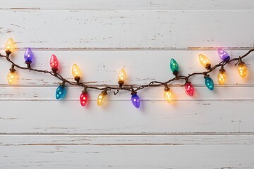 christmas lights garland on a white wooden background with copy space, top view christmas frame made of colorful light bulbs Generative AI