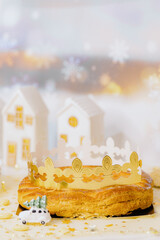 Fresh almond royal galette with crown on the table.