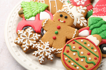 Tasty gingerbread cookies, marshmallows and Christmas decor on white textured table, closeup