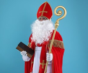 Fototapeta premium Saint Nicholas with book and crozier on blue background