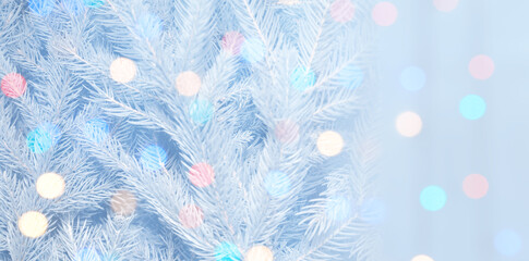 Christmas greeting card with fir tree branches and bokeh lights. Banner design