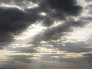 Dark and dramatic cloudy sky with god rays. Background for design.