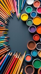 Top-down view of a collection of colorful pencils and paint pots arranged on a dark surface, creating a vibrant and creative composition.