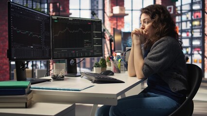 Day trader feeling worried and stressed looking at monetary losses, analyzing stock price trends on...