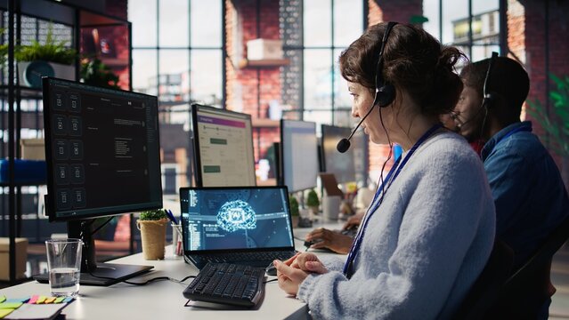 Worker providing live chat support, typing on keyboard, using AI chatbot to handle clients complaints. Call center agent dealing with unsatisfied customers using artificial intelligence LLM, camera B