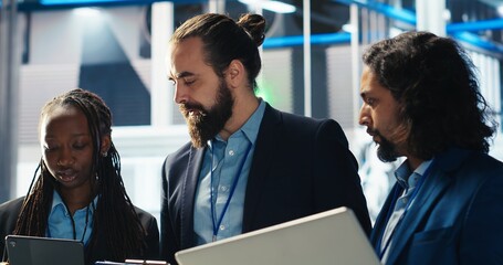 Team of photovoltaics factory engineers working together to improve solar panels efficiency....