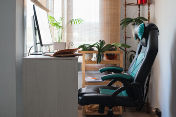 Home office workspace featuring computer desk and gaming chair