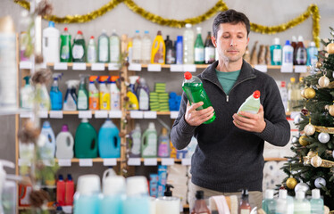 Man chooses dishwashing in a supermarket before Christmas