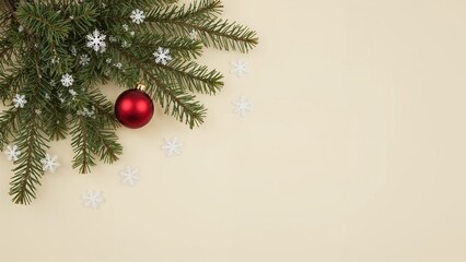 Christmas tree branches with red baubles and white snowflakes on a light background.