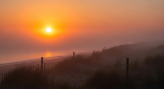Golden Sunrise Over the Misty Beach with Fence Silhouettes. - Powered by Adobe