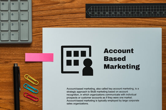 The dummy document of the Account Based Marketing is on the desk, along with a calculator and a pen.