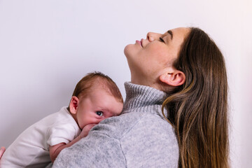 Mother embracing newborn baby boy with love