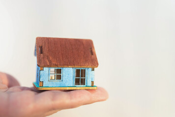 young man with house thinking.