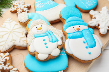 Tasty gingerbread cookies on white wooden table, closeup