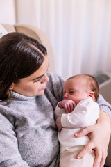 Mother embracing newborn baby creating a bond
