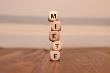 Miniature toy model house with inscription MIETE