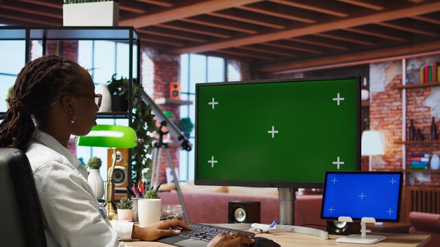 Woman browsing social media at home using isolated screen computer display and tablet. Person talking with friends on social network online website using chroma key PC and mockup device, camera A