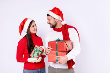 Happy couple with Christmas gifts on white background