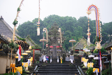 Balinese Temple During Rainy Day with Ceremonial Decorations in Penglipuran Village, Bali, Indonesia